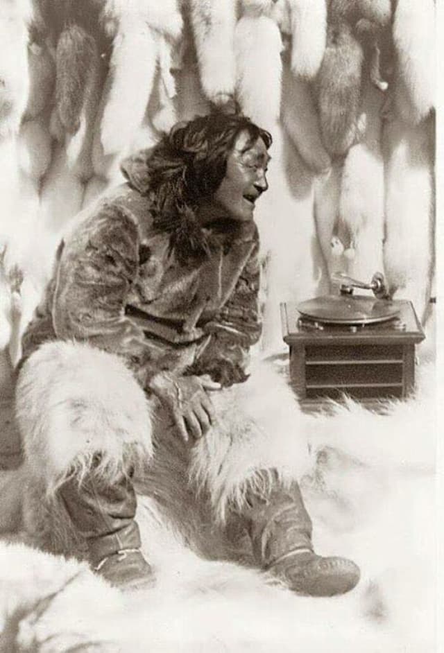 Original damaged photo of Inuit person with gramophone